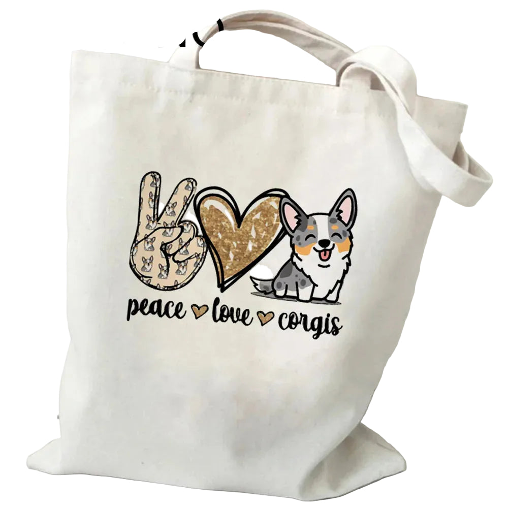 Cream canvas tote bag featuring a peace sign, heart and Corgi graphic with the words Peace Love Corgis