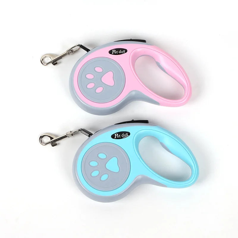 Pink and blue retractable dog leashes with paw print design, ergonomic handles and metal leash clips