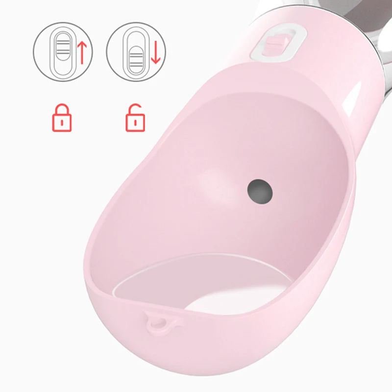 Close-up of a pink portable dog water bottle showing the lock and unlock button for water flow control