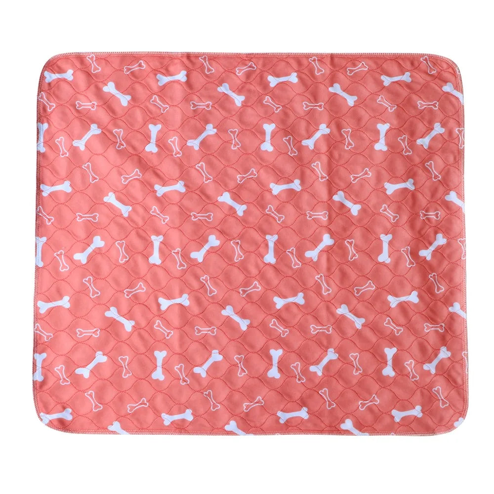 Pink quilted dog bed mat with white bone pattern, padded surface and rounded corners