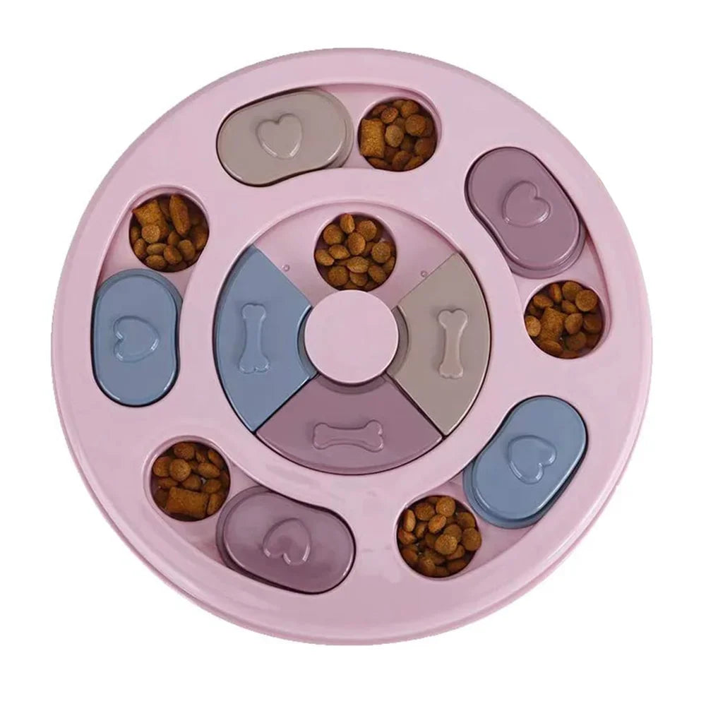 Pink round interactive dog puzzle feeder with sliding treat compartments filled with dry dog food