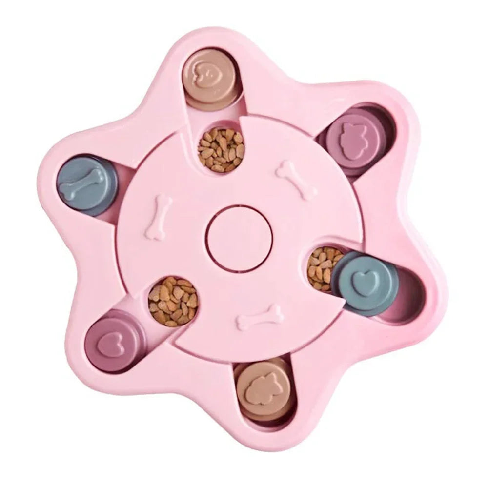 Pink star-shaped interactive dog puzzle feeder with sliding treat compartments filled with dry dog food