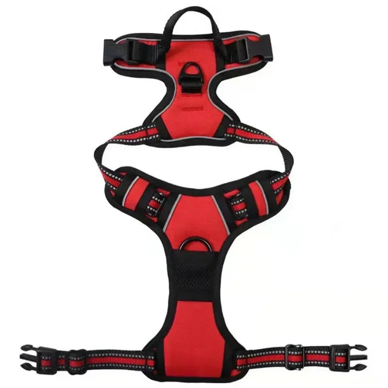 Red and black adjustable dog harness laid flat, showing padded panels, reflective straps, buckles, handle and leash attachment rings