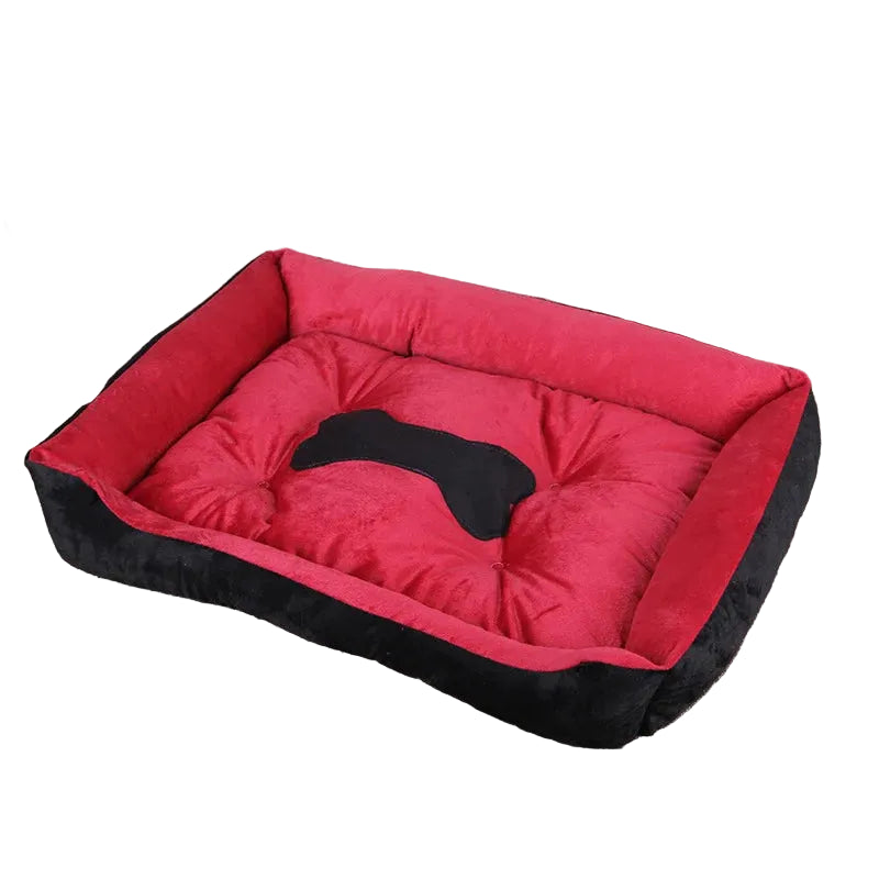 Red and black bolster dog bed with padded base, raised cushioned sides and black bone-shaped centre detail
