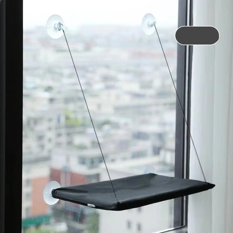 The hammock in black, mounted on a window