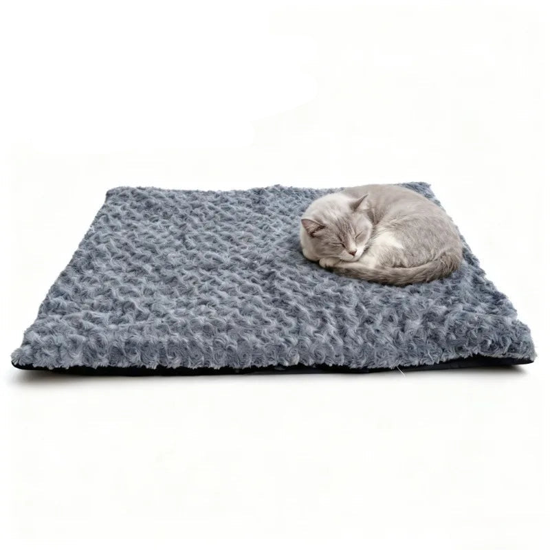 Grey cat sleeping curled up on a textured grey self-warming pet mat