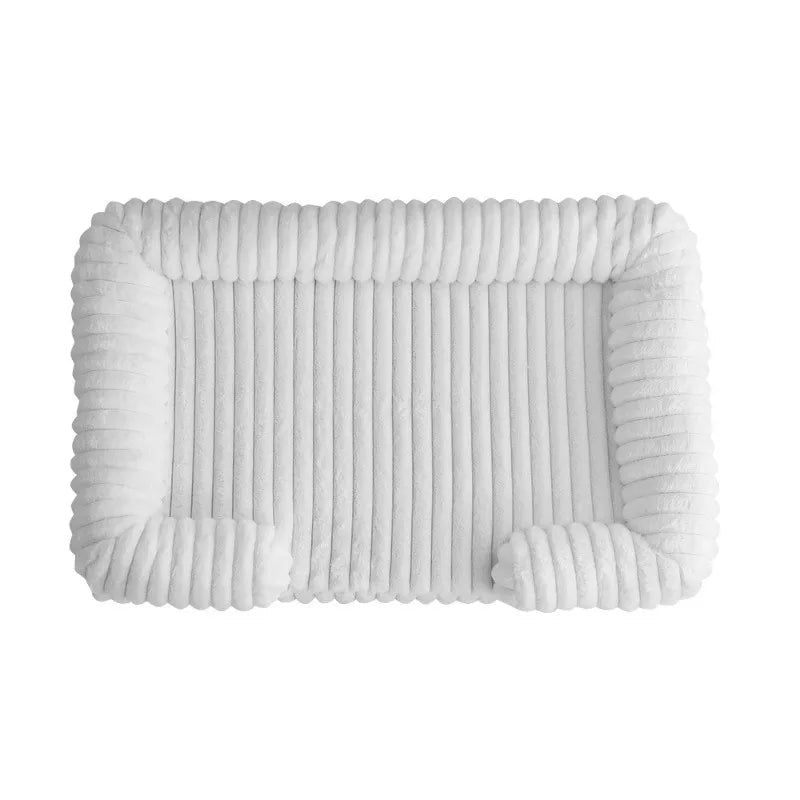 White ribbed dog bed with soft padded base and raised bolster sides for dogs